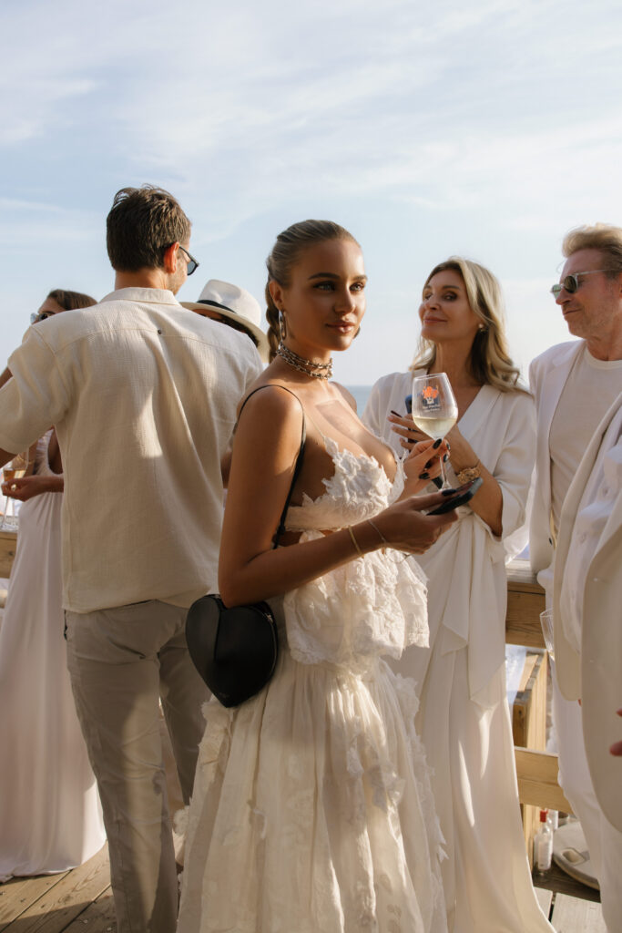 Wedding guest during cocktail hour at a destination wedding in Portugal, photographed by Australian destination wedding photographer Evelina Katarzynski
