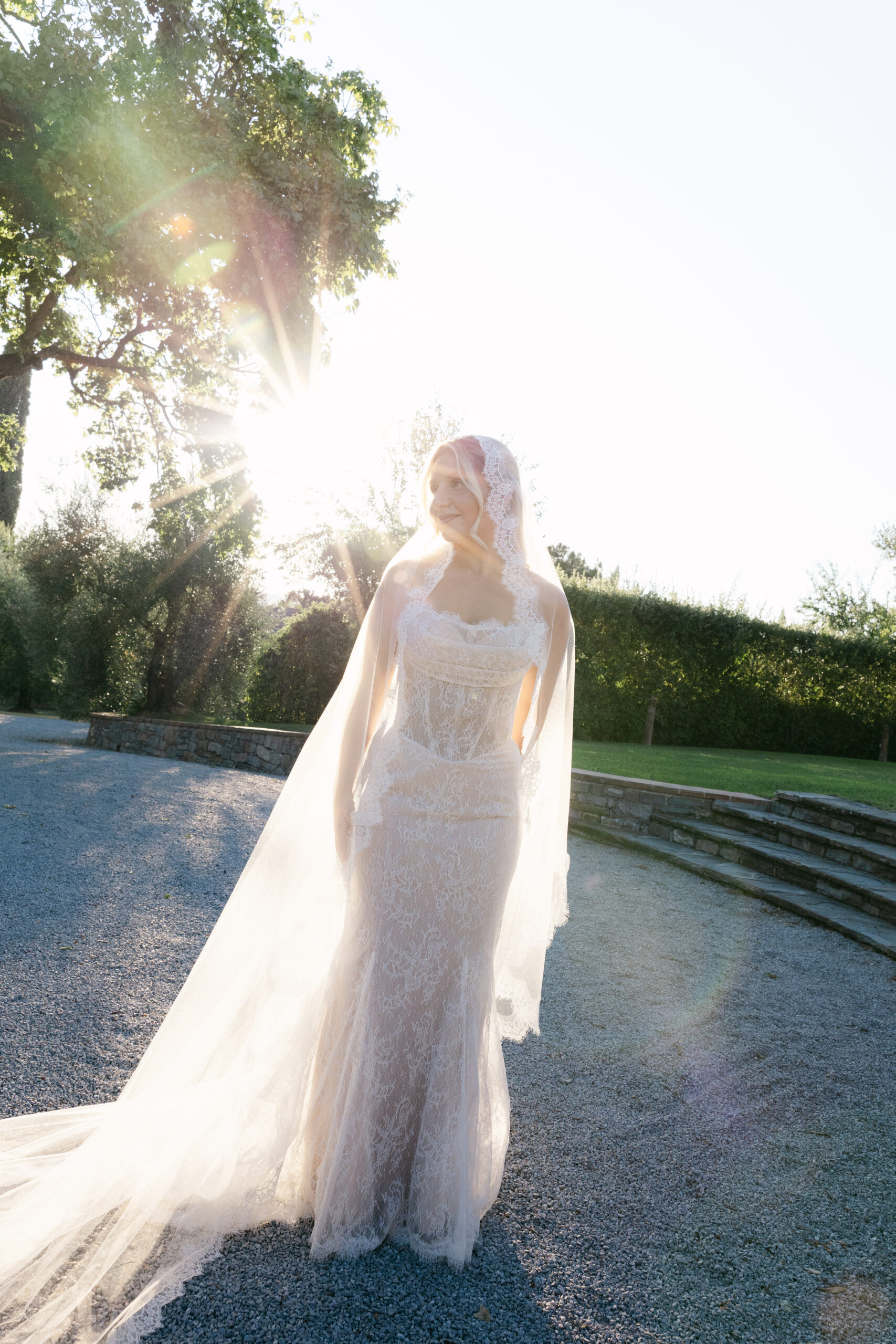 Bride in lace gown at golden hour in Tuscany Italy, photographed by Australian destination wedding photographer Evelina Katarzynski