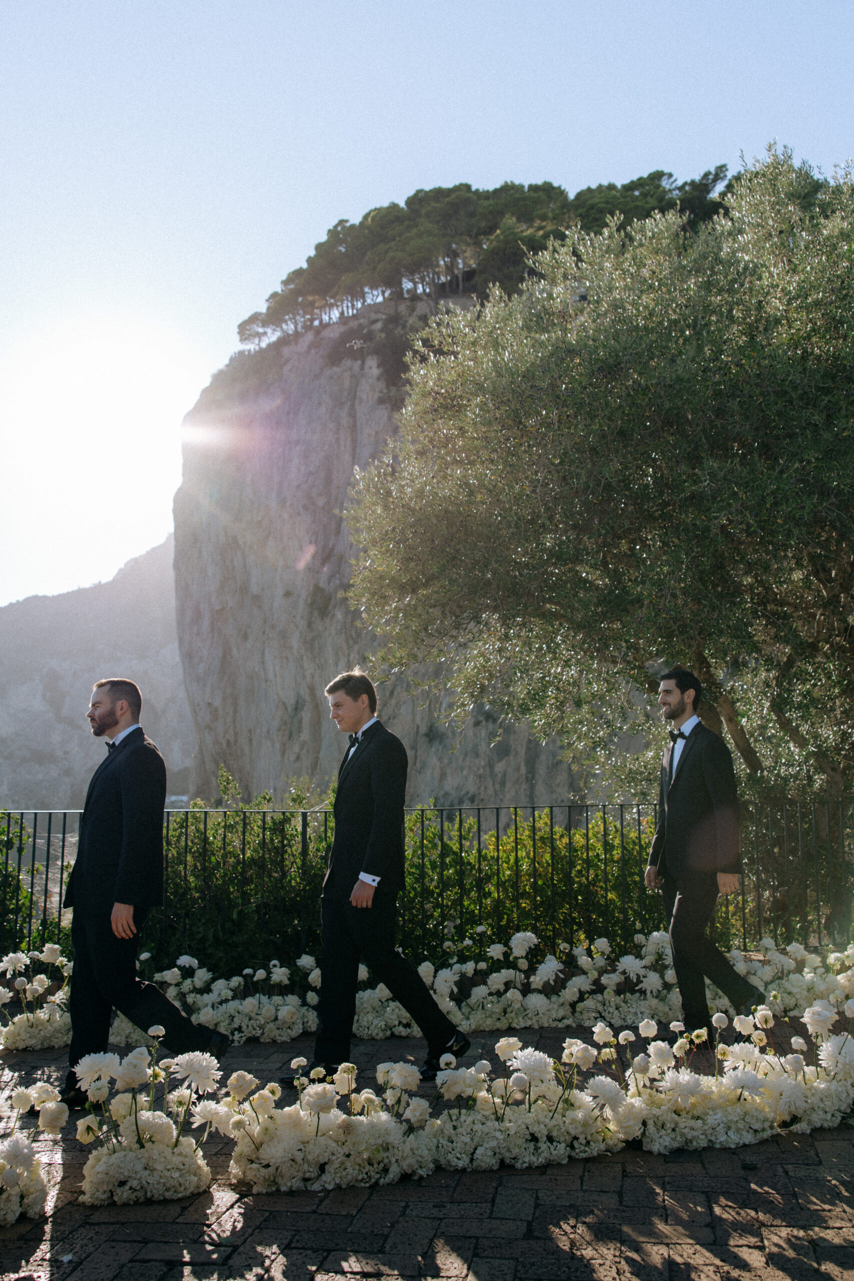 Groomsmen in tuxedos at a destination wedding ceremony in Capri Italy, photographed by Evelina Katarzynski