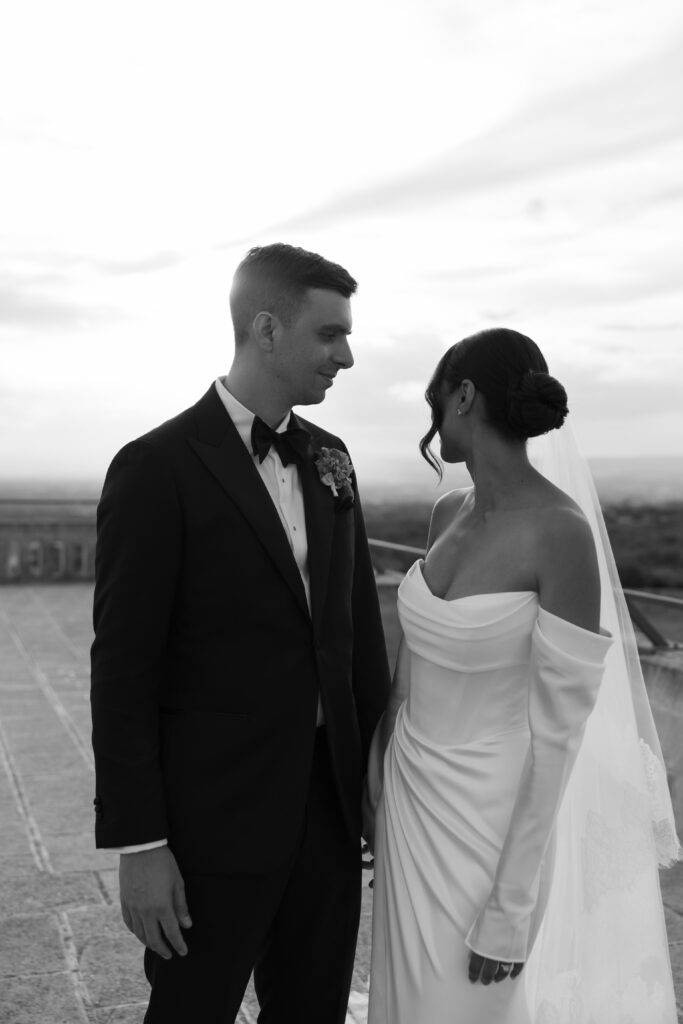 Black and white editorial wedding portrait of a bride and groom on a rooftop in Puglia, photographed at Masseria Amastuola by an Australian destination wedding photographer.
