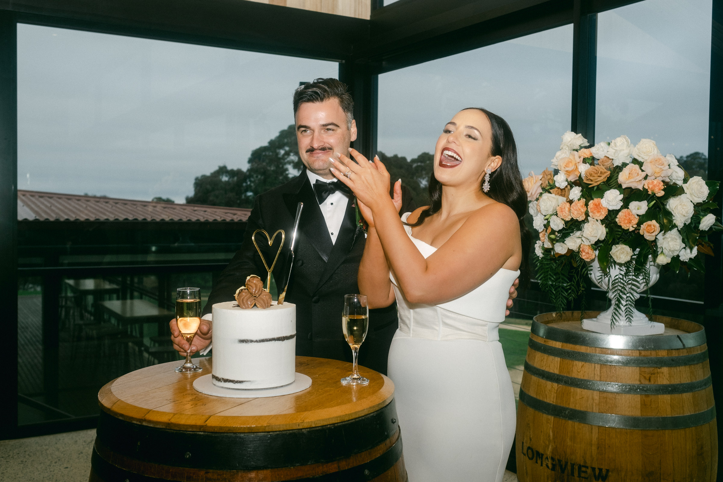 a bride and groom cut their wedding cake at an Adelaide Hills wedding venue