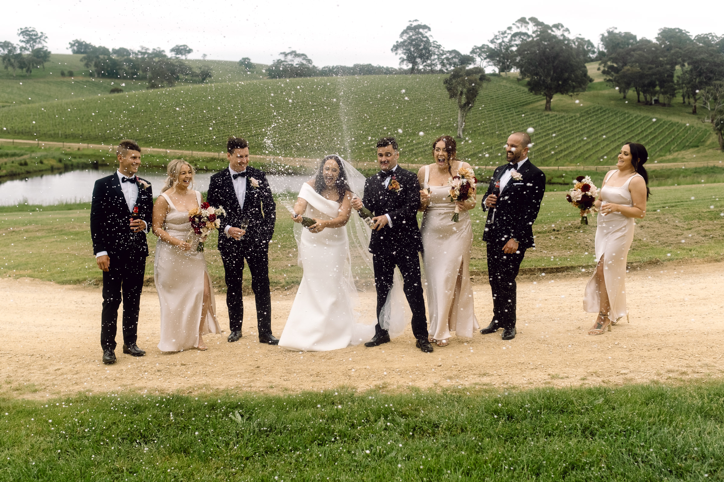 a bridal party spray champagne at their Adelaide Hills wedding