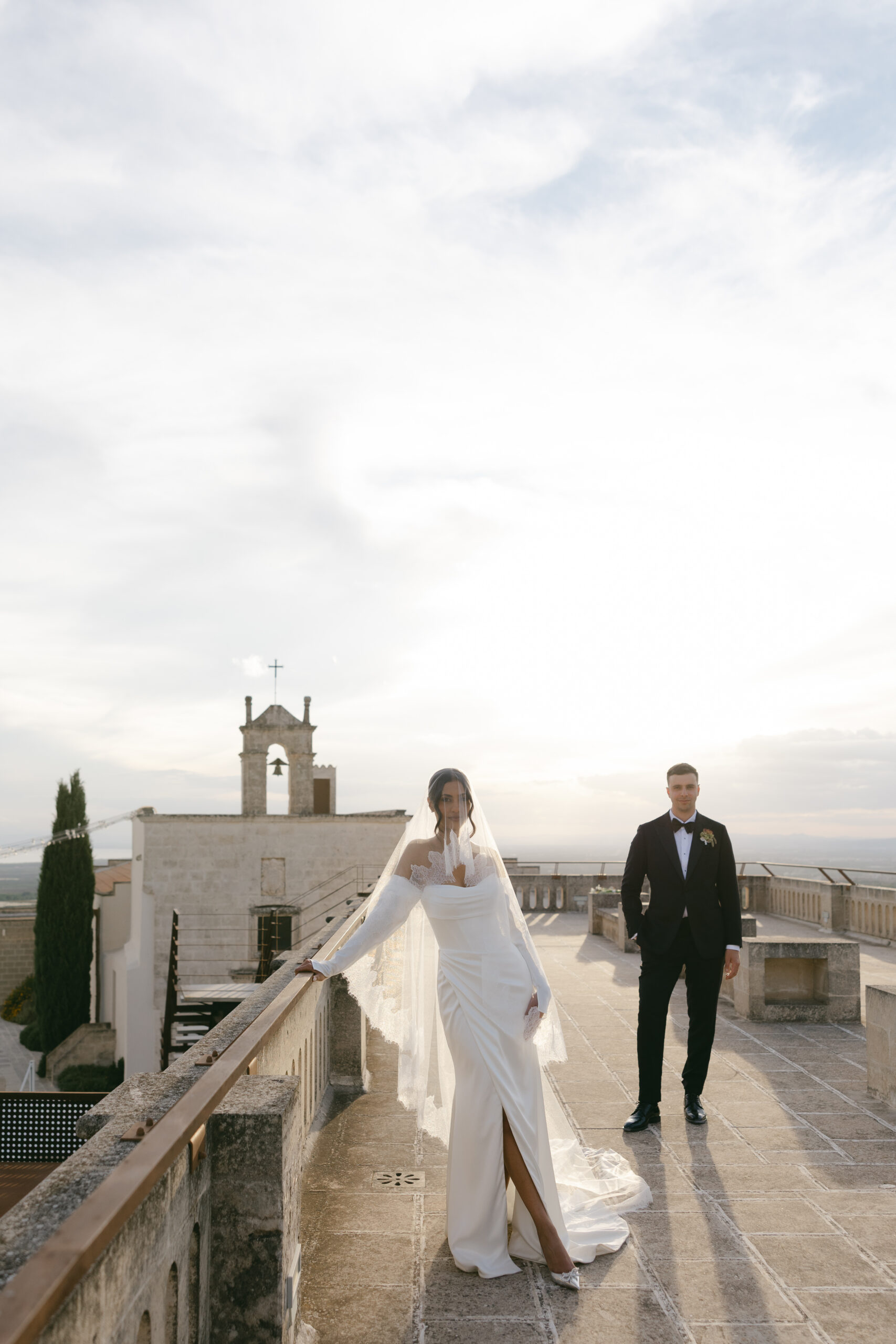Bride and groom portrait on a stone terrace in Italy, photographed by destination wedding photographer Evelina Katarzynski