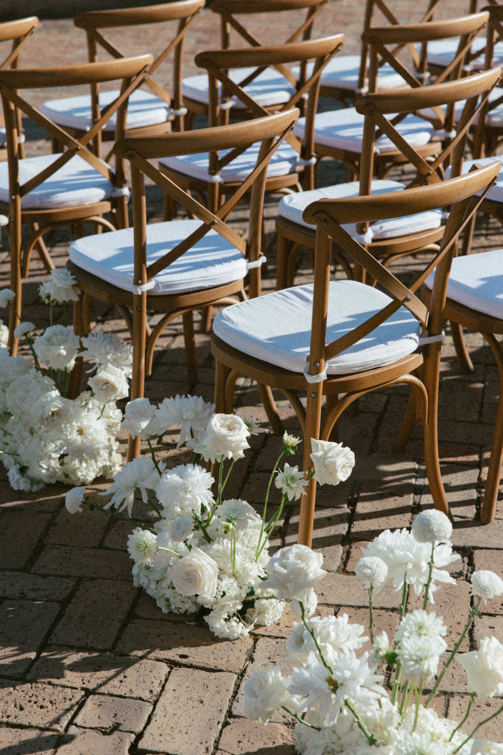 White floral arrangements along ceremony aisle at destination wedding in Capri Italy