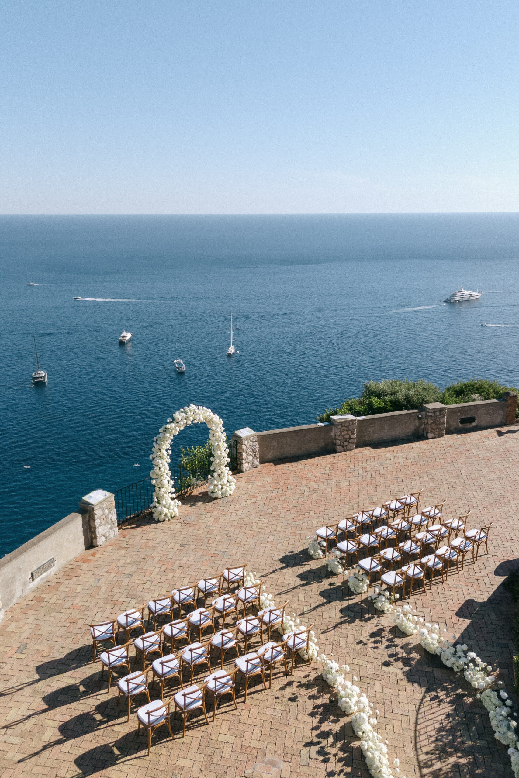 Outdoor destination wedding ceremony setup overlooking the sea in Capri Italy