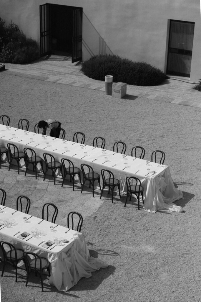 Long reception table set outdoors at Masseria Amastuola destination wedding venue Puglia Italy