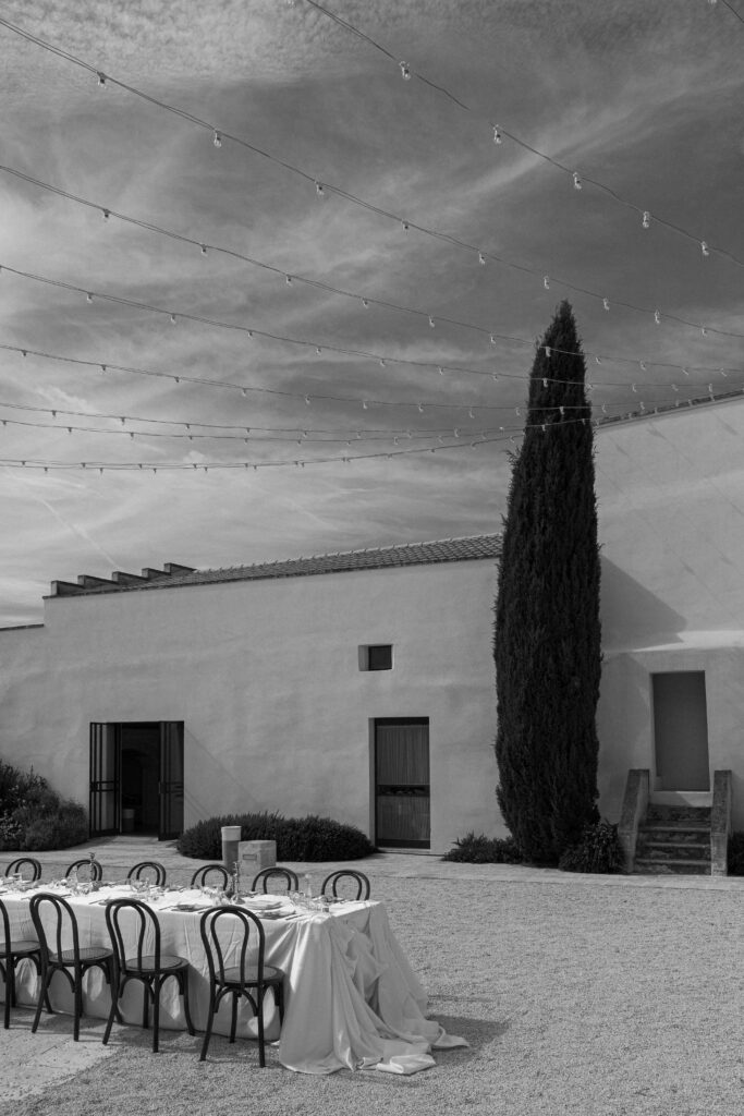 Outdoor destination wedding reception at Masseria Amastuola Puglia Italy with cypress tree and draped table