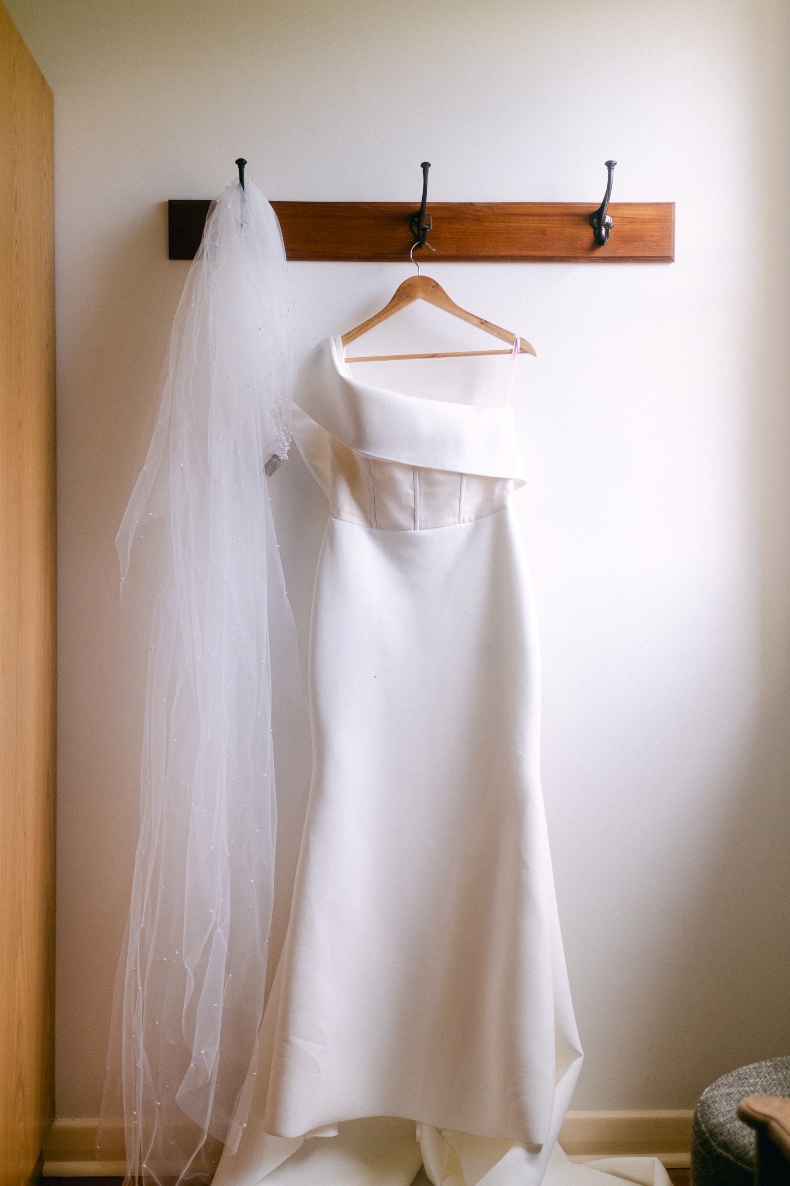 a brides wedding dress hangs in the bedroom of at Longview Vineyard in the Adelaide Hills