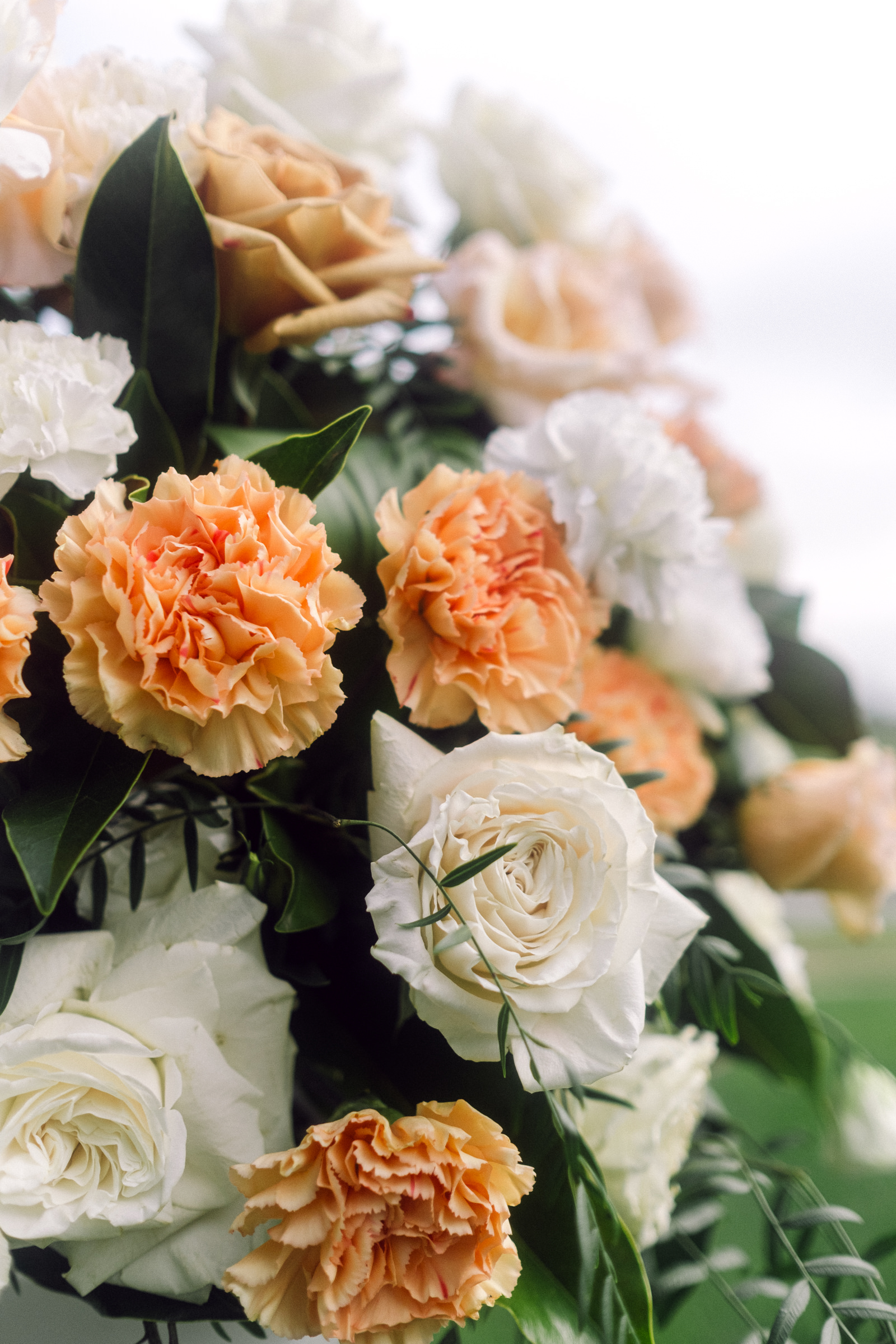 closeup shot of a peach and white floral arrangement