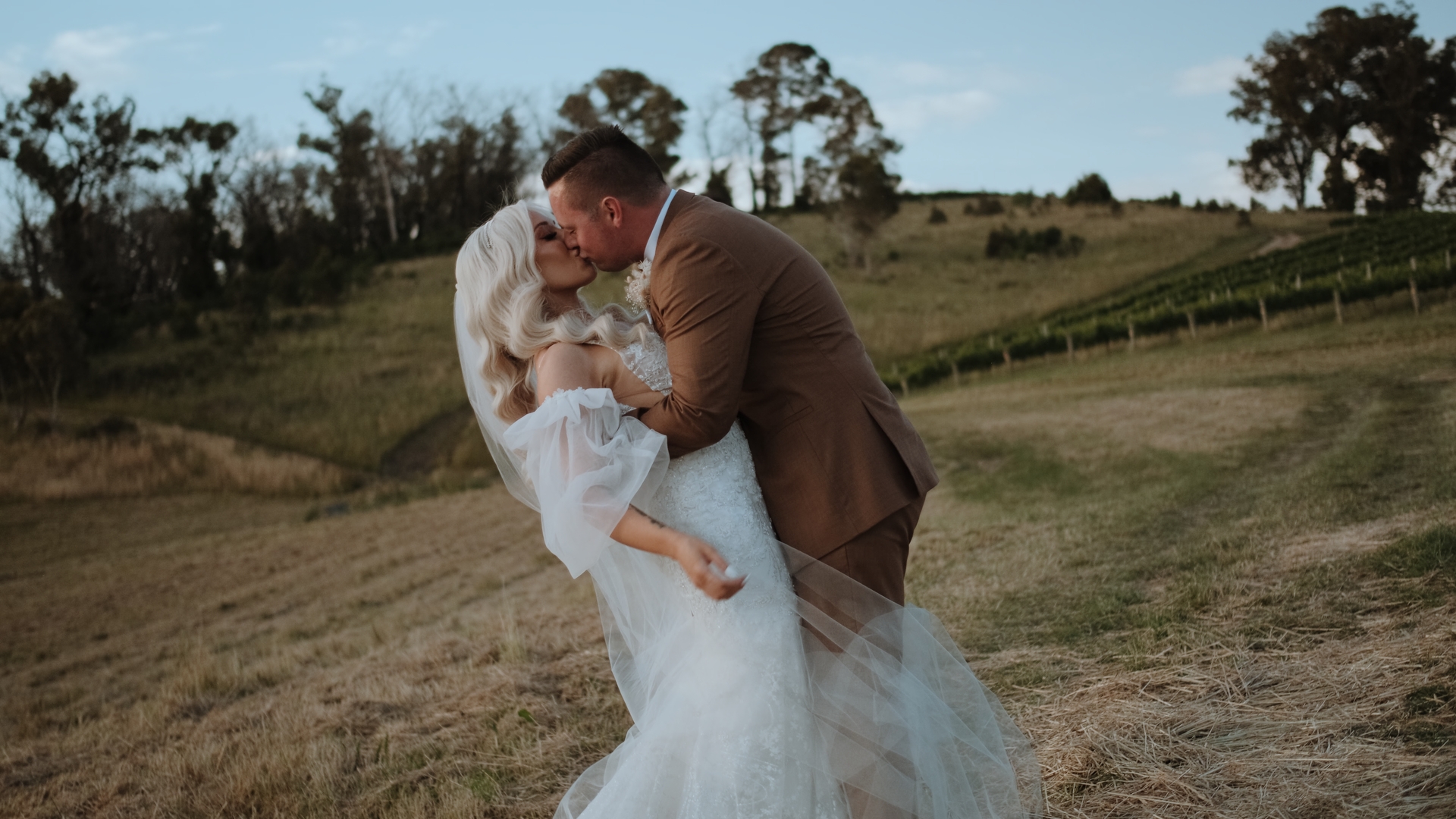 a bride and groom passionately kiss, a screengrab from their wedding videographer