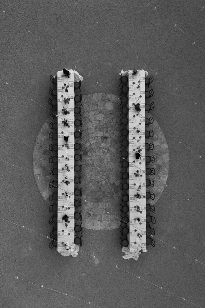 Ariel drone photograph of reception table dinner styling at a Puglia destination wedding in Amastuola Wine Resort