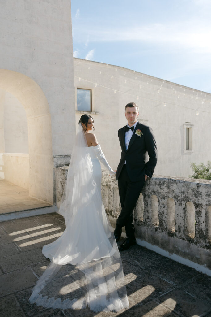 Bride and groom portrait along the stone terrace rooftop at Masseria Amastuola in Puglia
