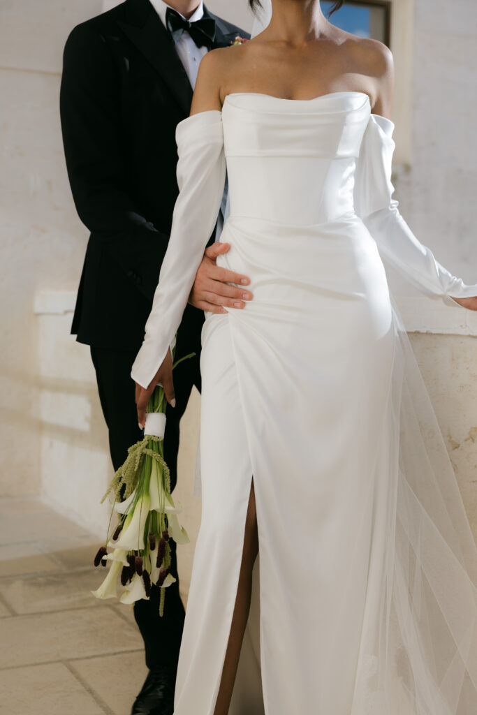 Editorial portrait of the bride in a Kyha Studios wedding dress during a first look with her groom in Puglia