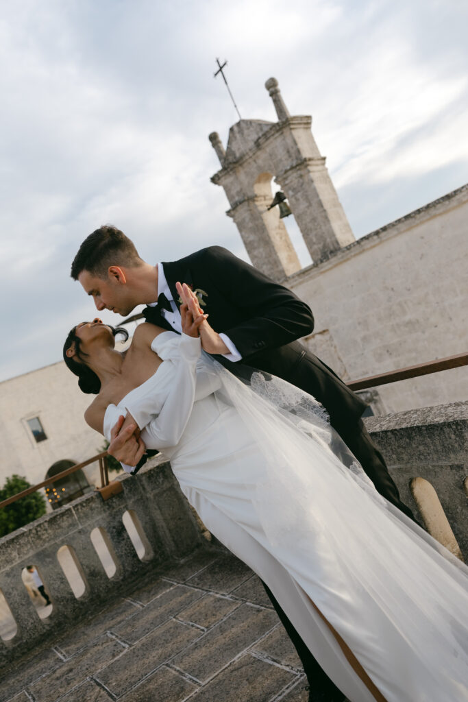 Bride and groom sharing a kiss on the terrace at Masseria Amastuola in Puglia