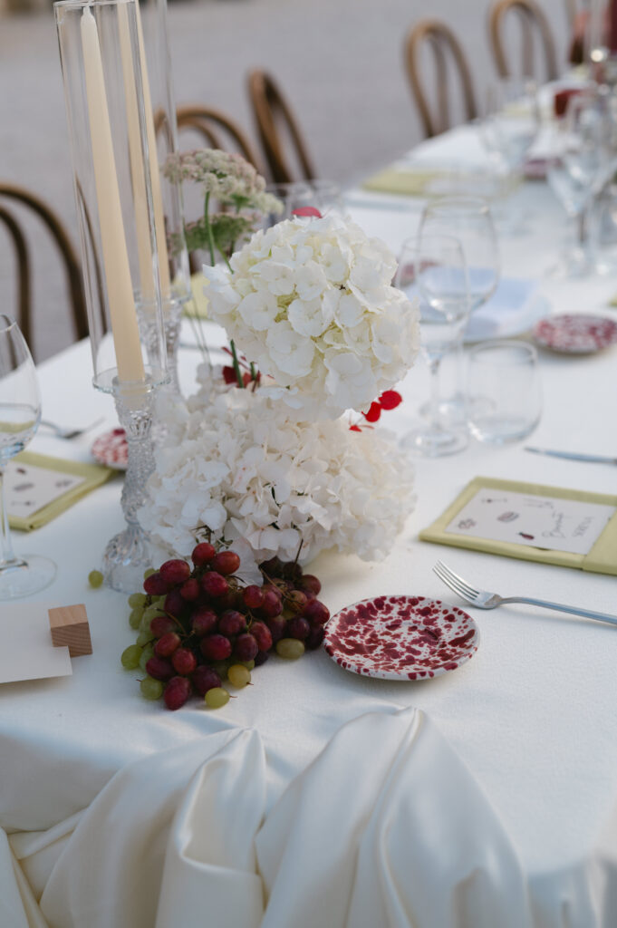 Wedding table styling with white florals and fruit details at Masseria Amastuola