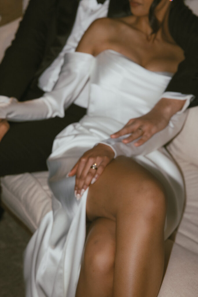 Bride and groom seated together in Kyha Studios wedding dress after sunset in Puglia