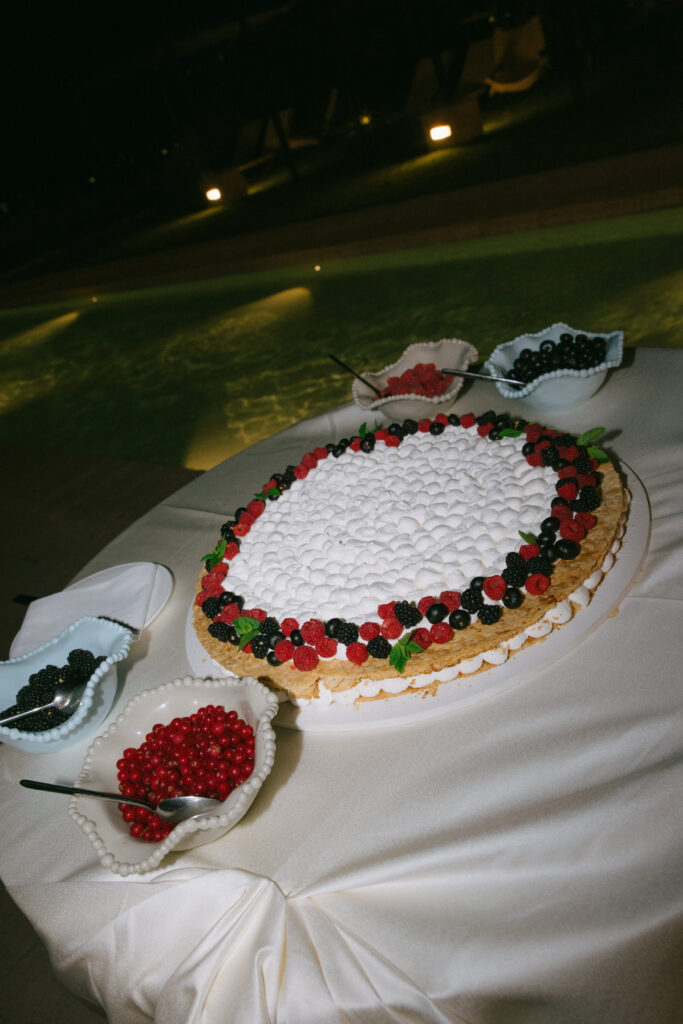 Wedding cake displayed outdoors during the evening reception at Masseria Amastuola in Puglia