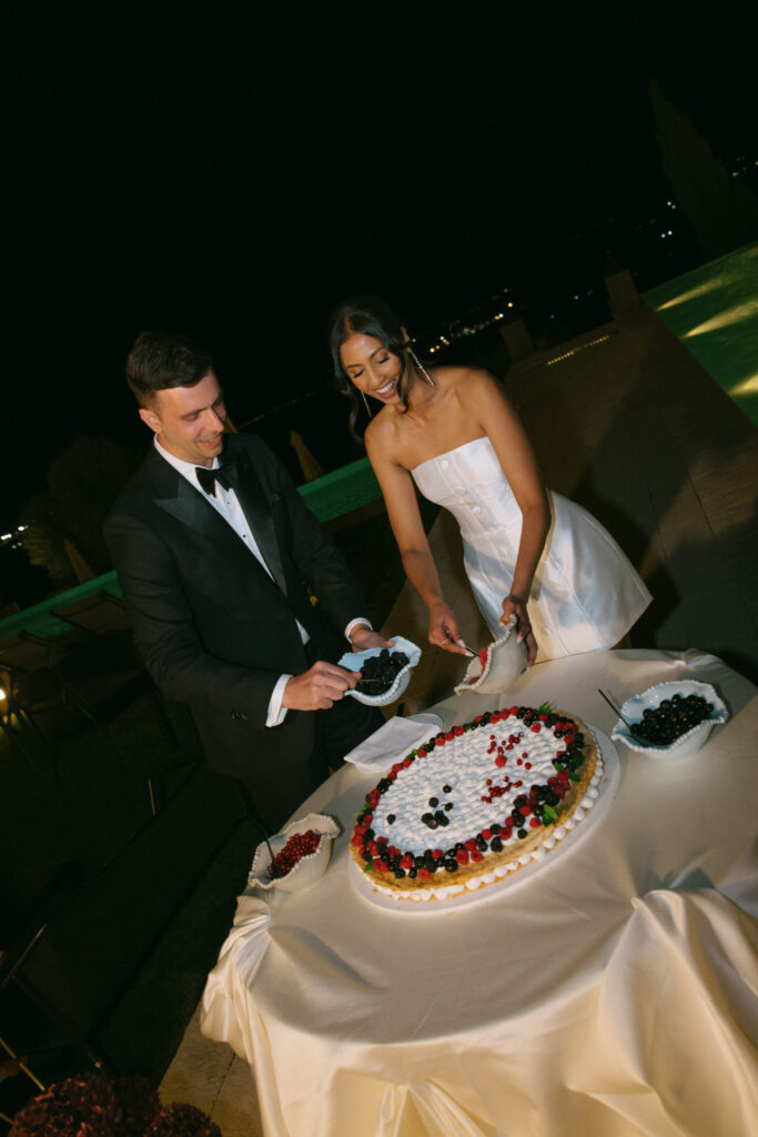 Bride and groom cutting their wedding cake during the evening reception at Masseria Amastuola