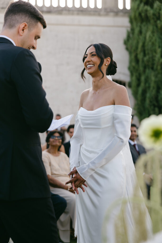 Bride smiling during the wedding ceremony at Masseria Amastuola in Puglia