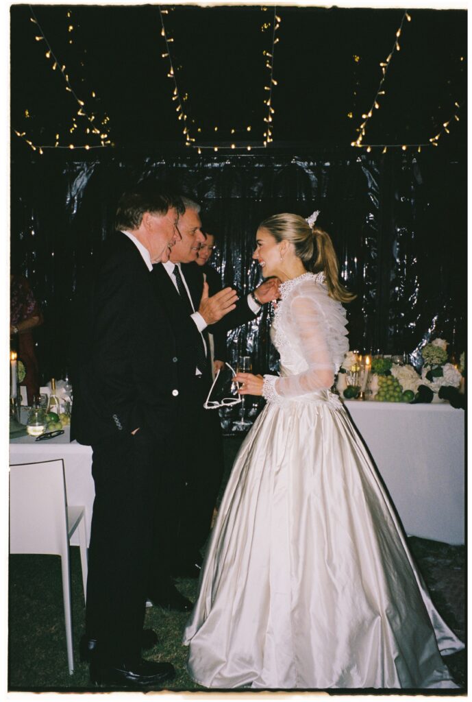 35mm film wedding photography, bride at evening reception under fairy lights, bride in full skirted gown, Evelina Katarzyński
