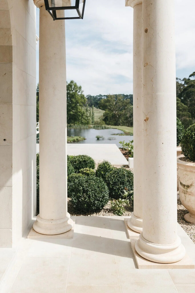 Stone columns and manicured hedges overlooking a lake at La Gemme Estate wedding venue, Bowral Southern Highlands NSW Australia