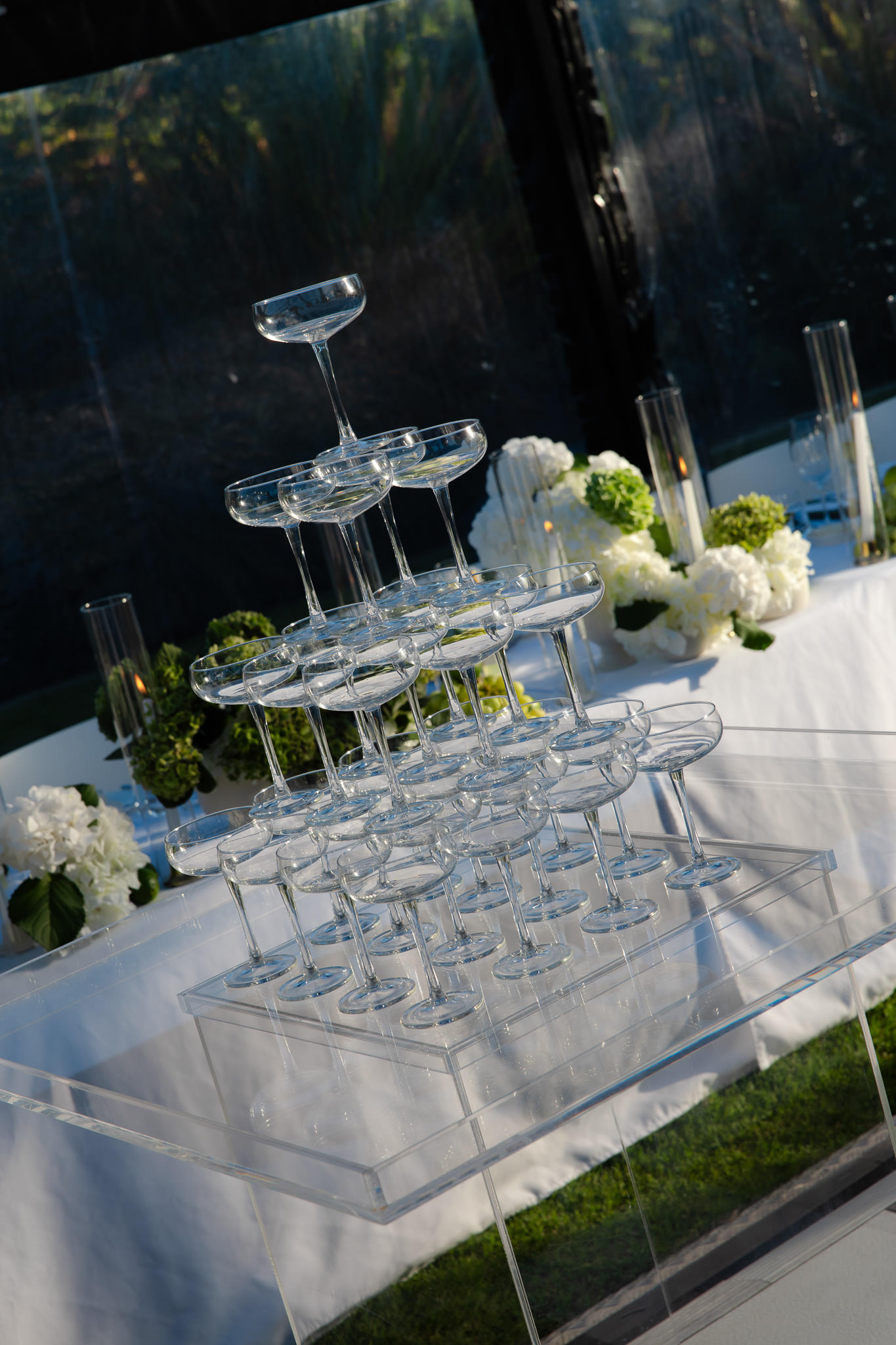 Australian wedding planner styled reception tablescape with champagne tower and white florals.