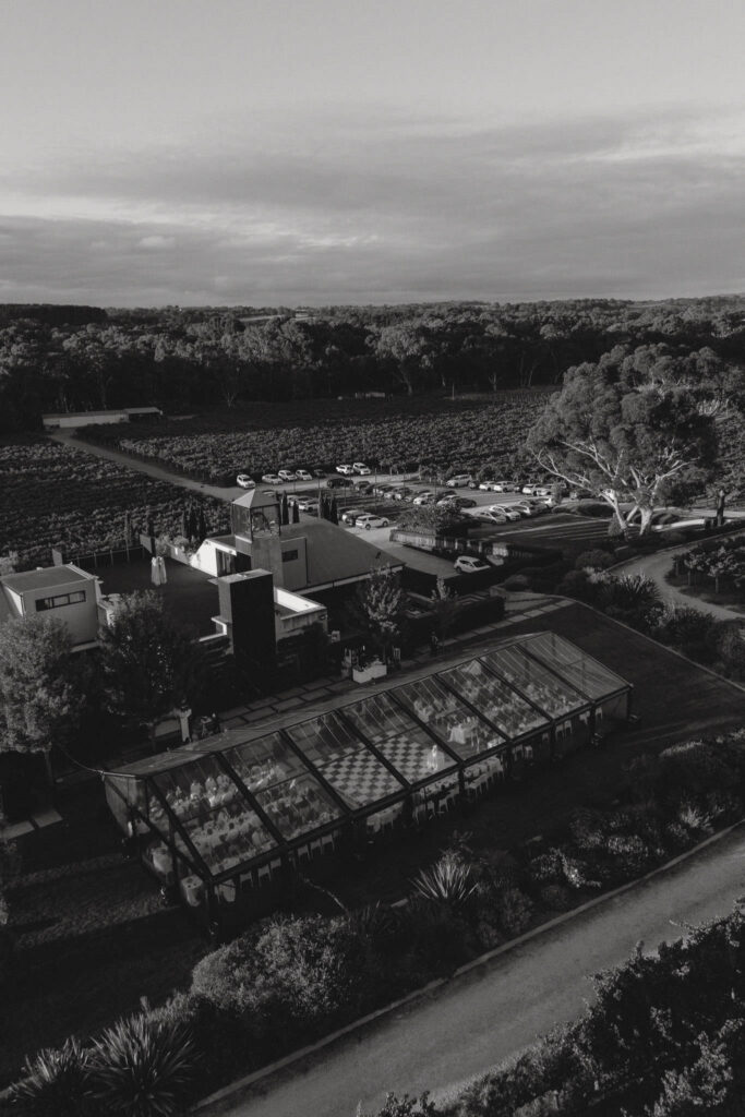 Aerial black and white view of the Beresford Estate wedding marquee on the Pepper Tree Lawns, surrounded by vineyard in McLaren Vale.